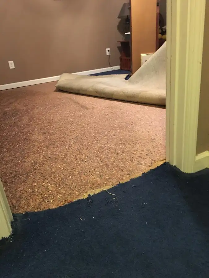 Carpet pad removal revealing water damage during Water Mitigation Services in Cathedral City